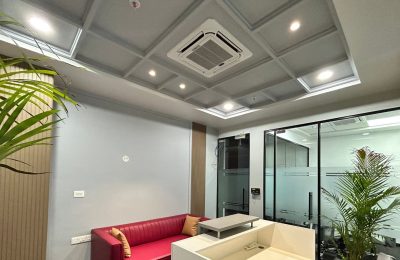 Ceiling cassette air conditioner installed in an office lobby, providing even cooling and maintaining a comfortable temperature for visitors.