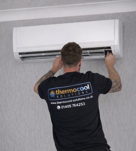 thermocool Technician servicing air conditioning unit